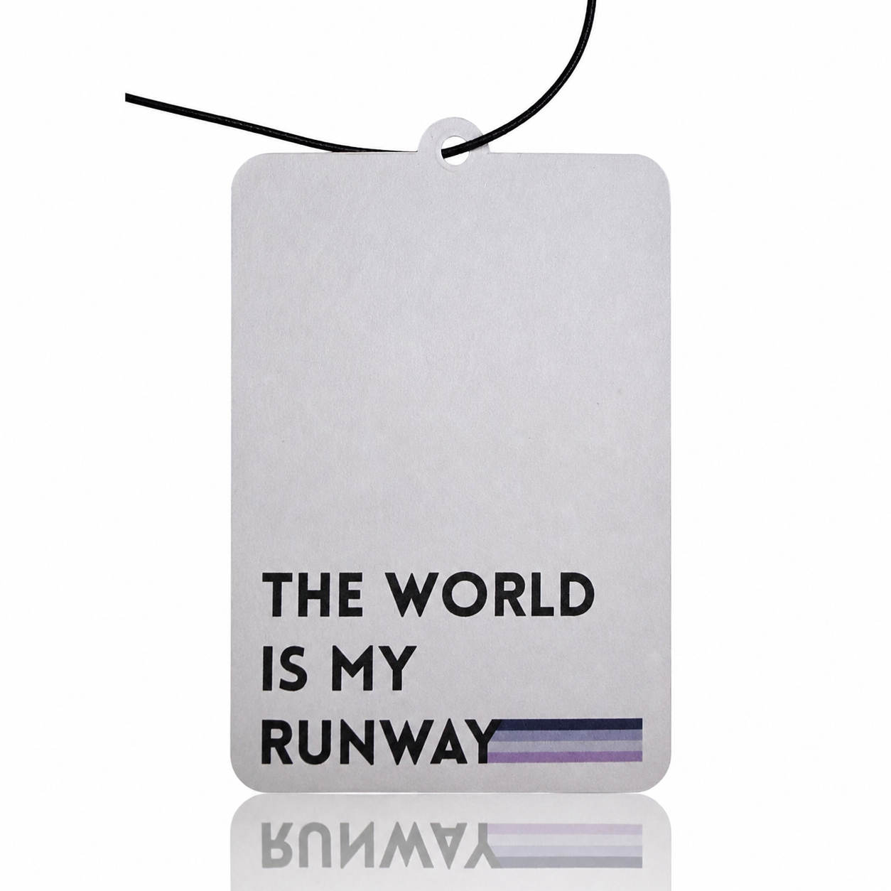 White car air freshener with 'The World is My Runway' text and Yawayna branding.