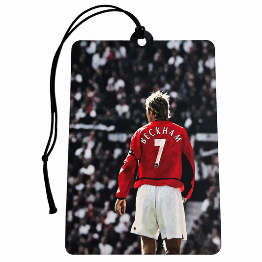 David Beckham inspired car air freshener featuring his iconic Manchester United red number 7 shirt, white shorts, stadium crowd and black hanging cord.