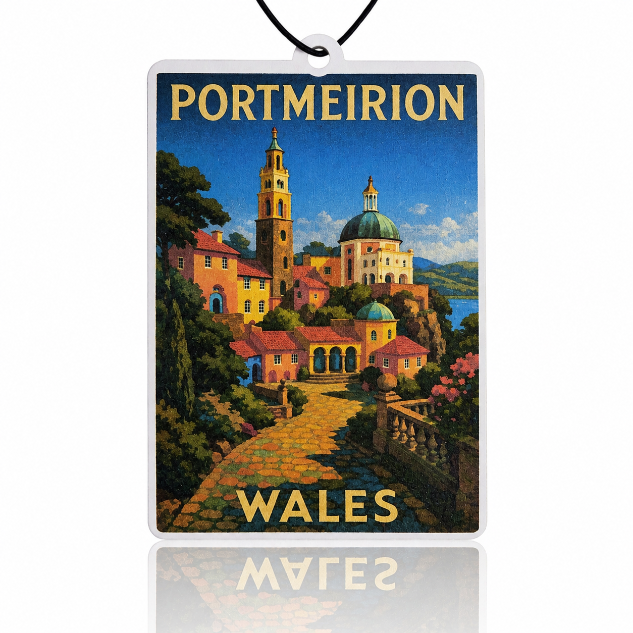 Decrotive car air freshener with a scenic view of Portmeirion, Wales, featuring colorful buildings and a lake.
