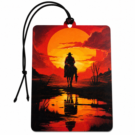 Rectangular car air freshener tag featuring a red and orange sunset landscape with a silhouetted cowboy on a horse, attached to a black hanging cord on a white background.