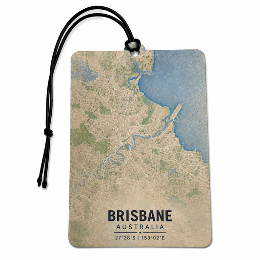 A rectangular Brisbane city map luggage tag with a black hanging cord, featuring a vintage-style map design in beige, blue, and green with the text 'BRISBANE AUSTRALIA' and coordinates at the bottom.
