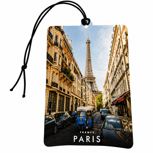 Rectangular Paris car air freshener or hanging tag with a black cord loop, printed with a street scene featuring the Eiffel Tower, buildings, cars, and the text 'FRANCE PARIS' at the bottom, shown on a white background.