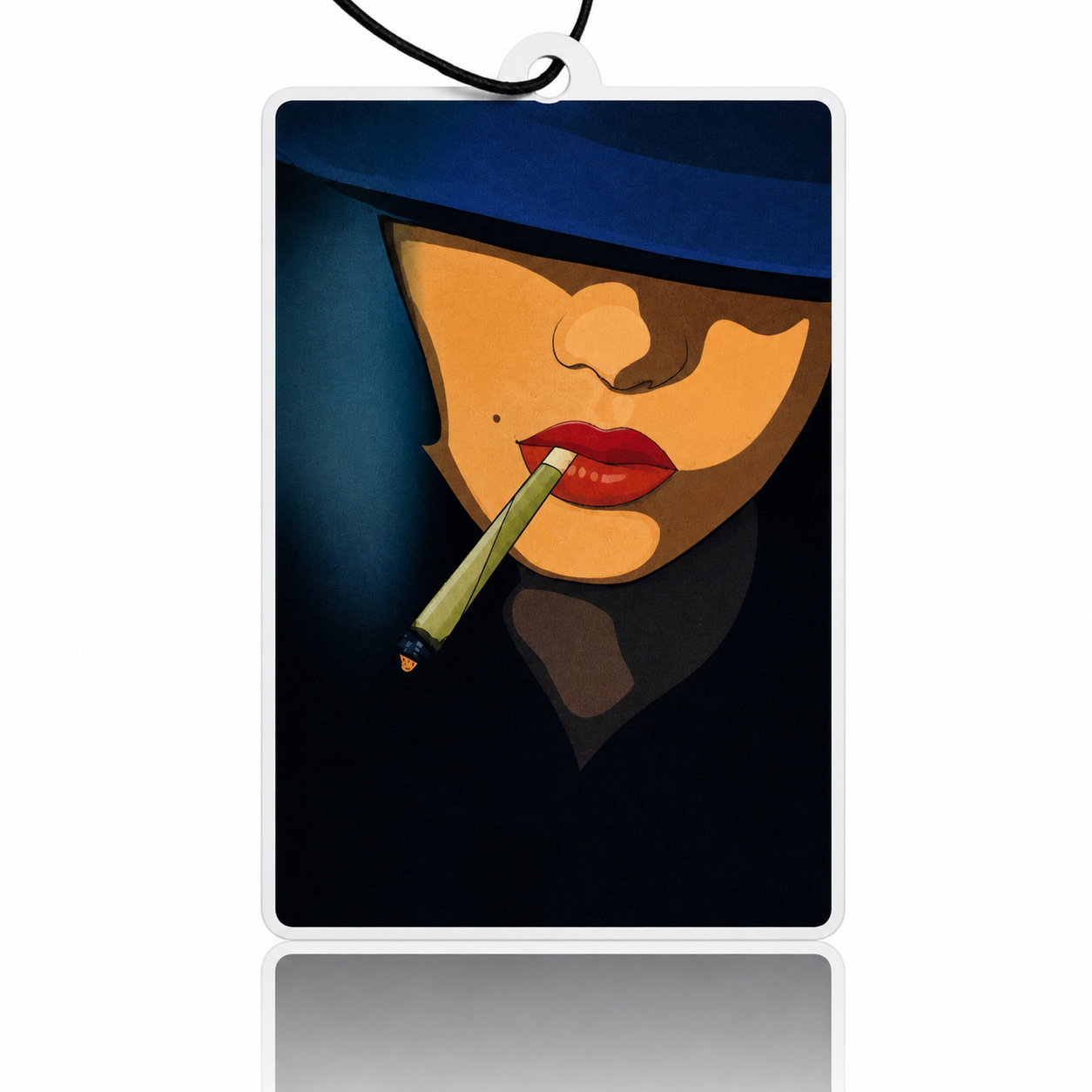 Rectangular car air freshener with a stylized face design on a dark background