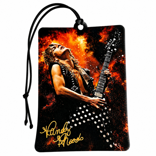 A rectangular car air freshener or luggage tag with a black hanging cord, featuring a printed graphic of Randy Wood of Guns N' Roses playing an electric guitar against a fiery orange and black background, with his name in yellow script at the bottom.