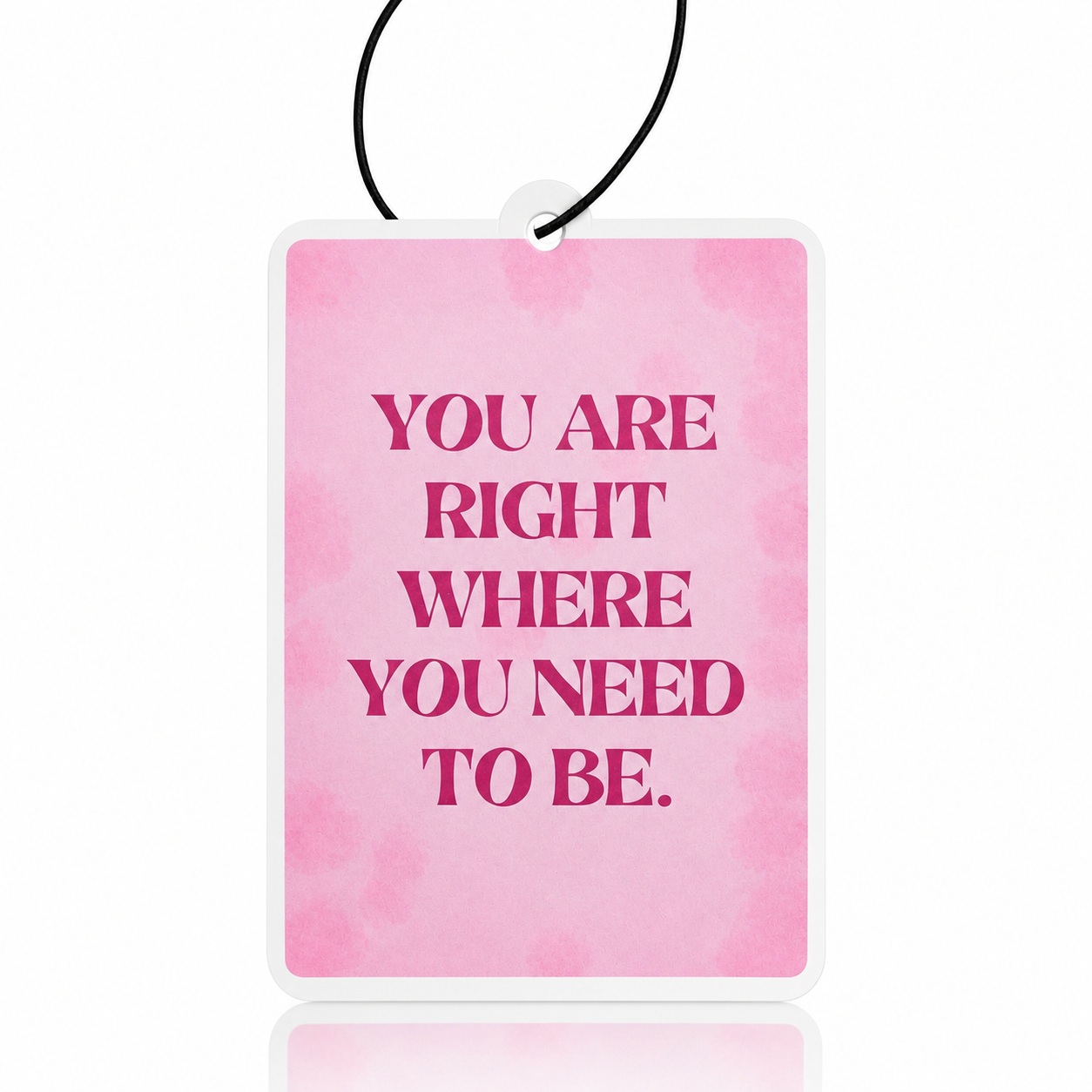 Pink watercolor car air freshener with motivational quote on a white background