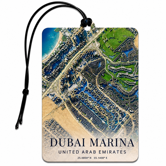 A rectangular luggage tag featuring an aerial map print of Dubai Marina, United Arab Emirates, with a black hanging cord and the text 'DUBAI MARINA', 'UNITED ARAB EMIRATES', and coordinates at the bottom, shown on a white background.