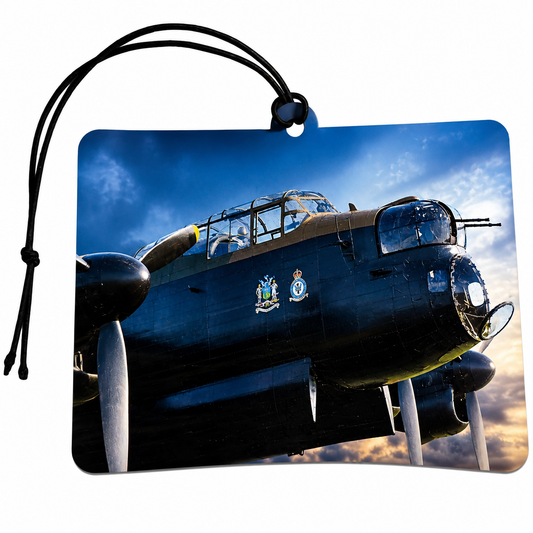 Rectangular car air freshener tag featuring a printed photograph of a dark blue military propeller plane against a blue sky with sunset clouds. The tag has rounded corners, a black hanging loop, and a small round hole at the top.