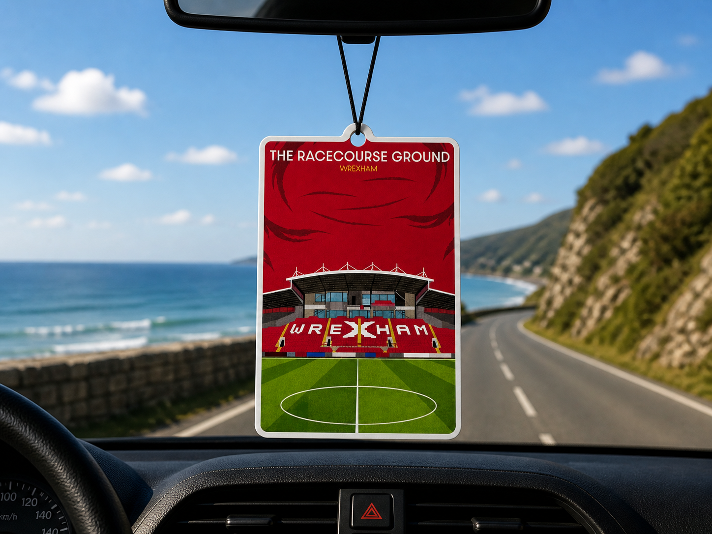 Car air freshener with Wrexham football ground design hanging from a rearview mirror.