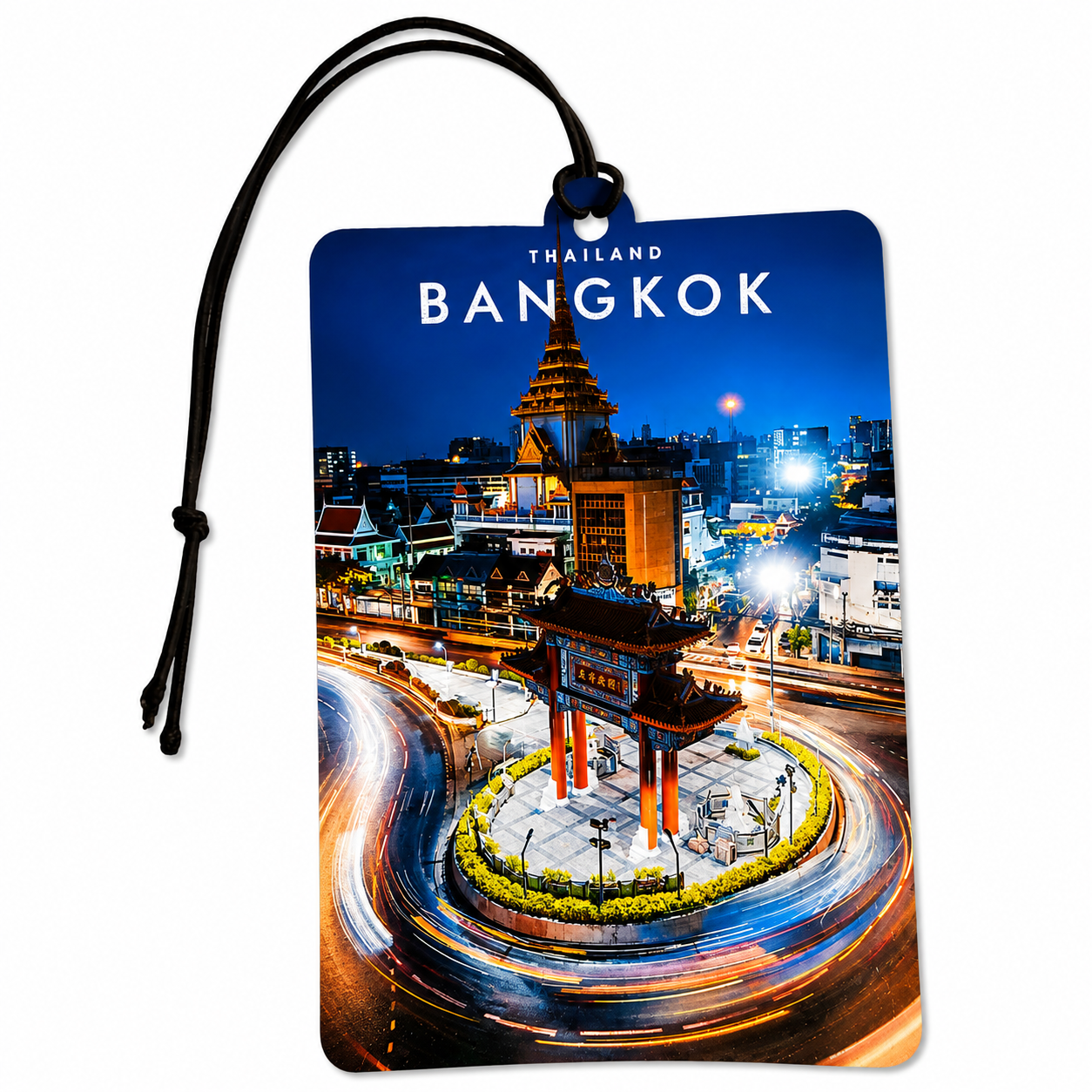 A rectangular luggage tag with a black hanging cord, printed with a colorful night photograph of Bangkok featuring a roundabout and illuminated buildings. The words 'THAILAND BANGKOK' appear at the top of the print, shown on a plain white background.