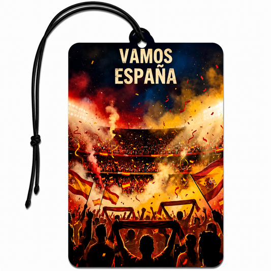 A rectangular car air freshener or luggage tag with a black hanging cord, featuring a vibrant stadium scene with fans, flags, smoke, and the text 'VAMOS ESPAÑA' at the top. The design is dominated by red, yellow, and black tones.