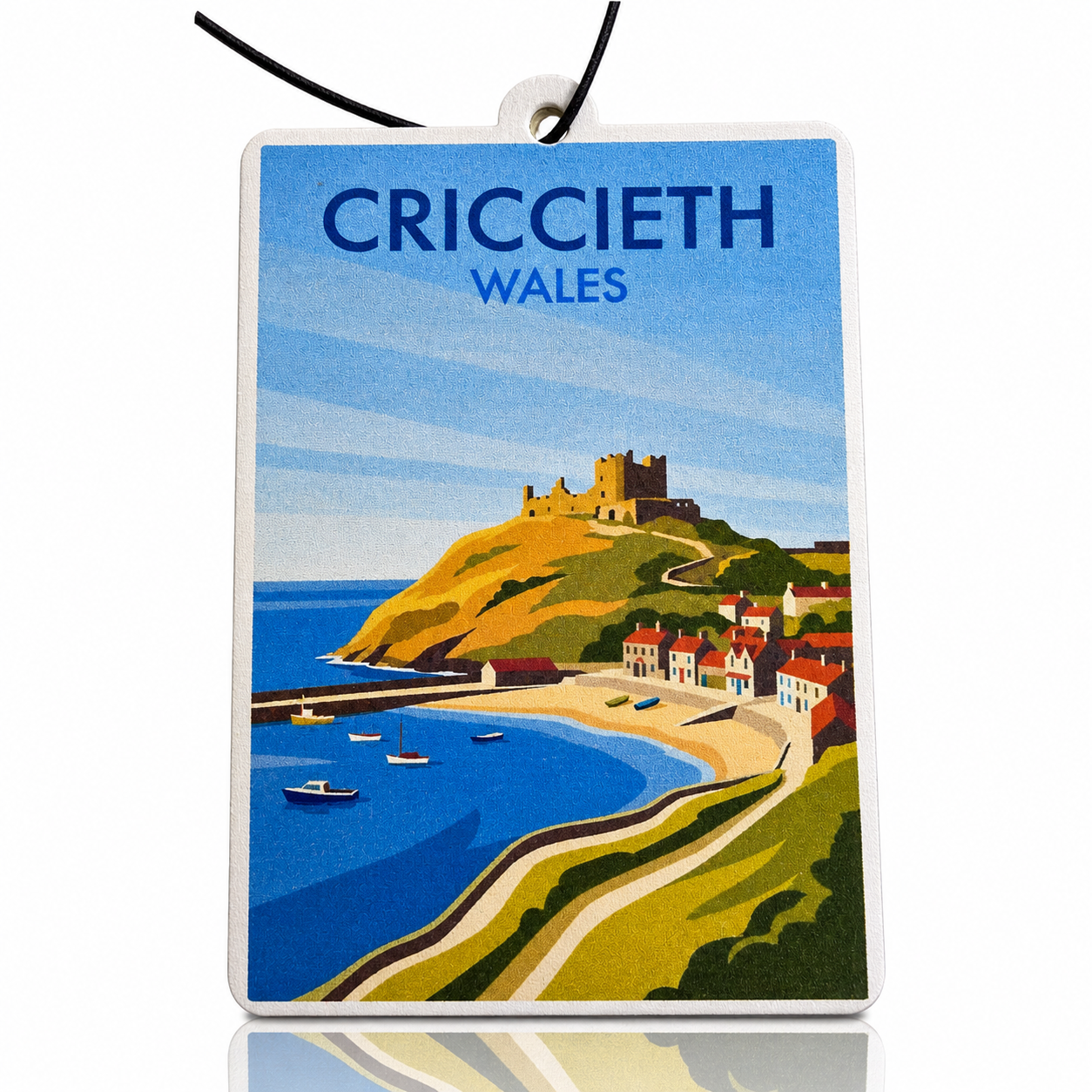 Car air freshener with a scenic view of Criccieth, Wales, featuring a castle and coastal town.