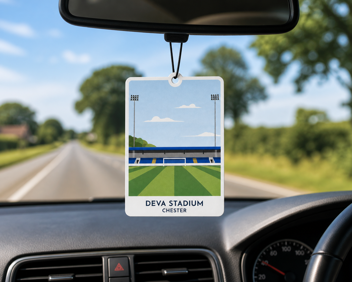 Car air freshener with Deva Stadium design hanging from a car's rearview mirror.