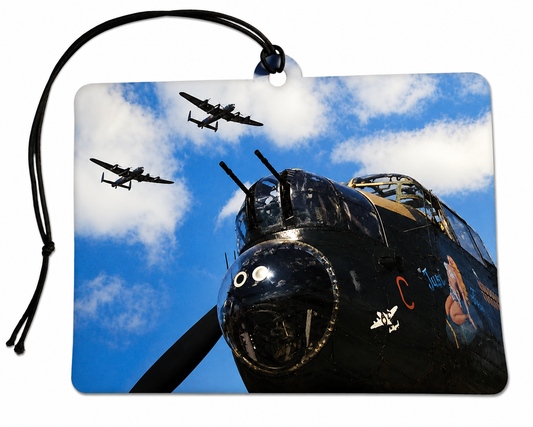 Avro Lancaster bomber inspired car air freshener featuring a dramatic close-up of a classic WWII British heavy bomber with aircraft flying overhead against a blue sky.