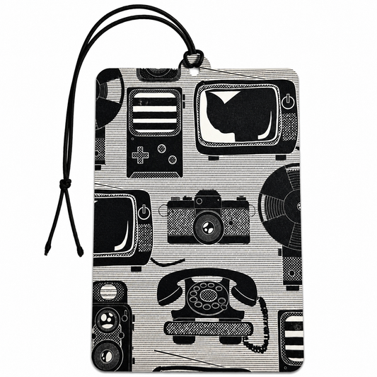 A rectangular car air freshener with a black and white retro pattern of vintage televisions, cameras, record players, and rotary phones, featuring a black hanging loop at the top.