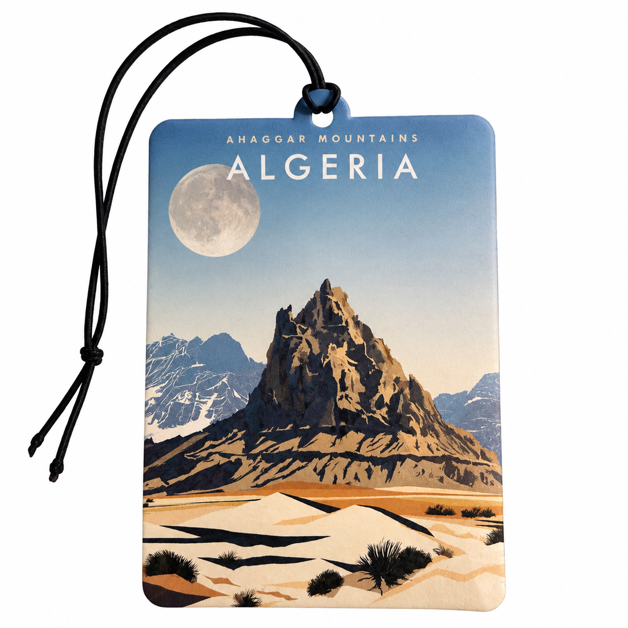 A rectangular car air freshener or travel tag featuring a stylized illustration of the Ahaggar Mountains in Algeria under a full moon, with a black hanging cord, shown on a plain white background.