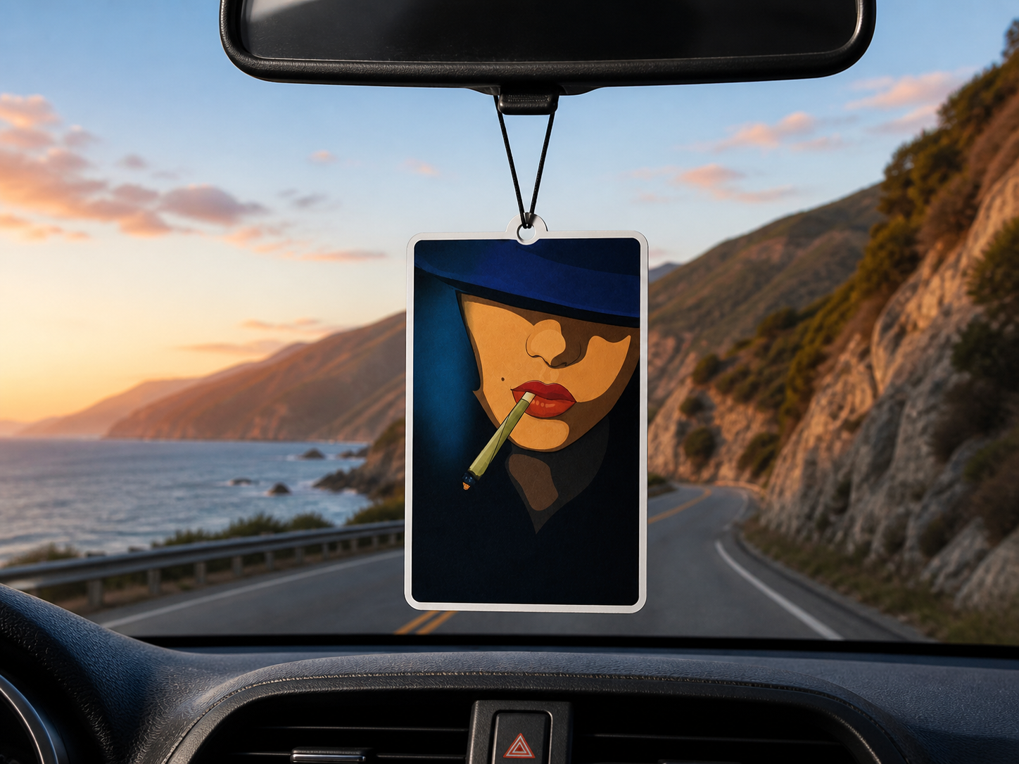 Car air freshener with a scenic road and ocean view in the background