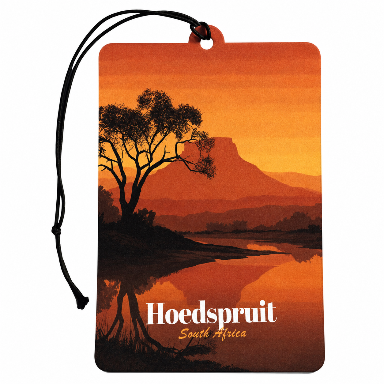 A rectangular car air freshener tag with a black hanging cord, featuring a scenic orange sunset landscape of Hoedspruit, South Africa, with a tree silhouette and the text 'Hoedspruit South Africa' printed on it.