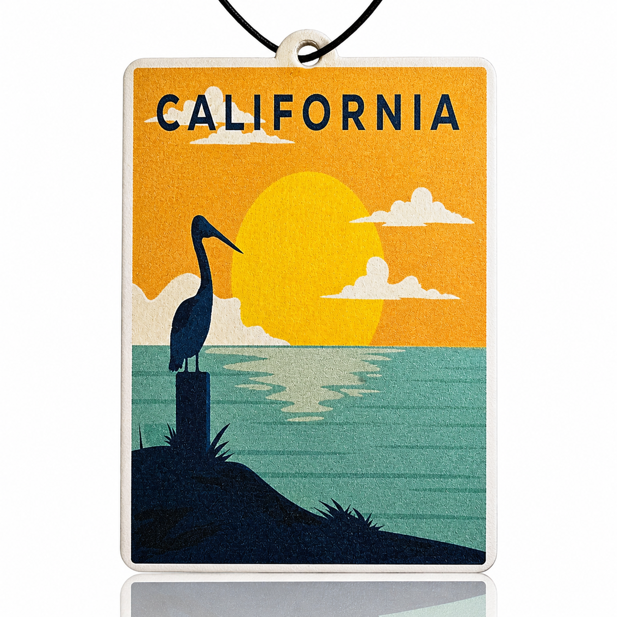 Decorative car air freshener with a pelican silhouette, sunset, and 'California' text on an orange and blue background.