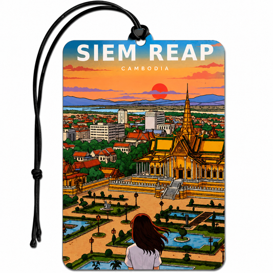 A rectangular luggage tag or car air freshener with a black hanging cord, featuring a colorful illustrated travel scene of Siem Reap, Cambodia, with a sunset, temple, cityscape, and a woman looking out over the gardens.