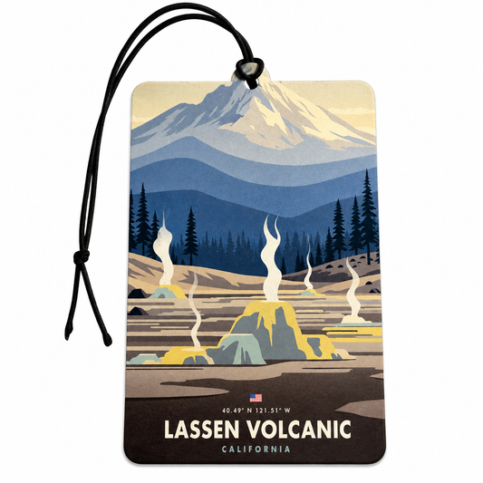 A rectangular car air freshener featuring a stylized travel poster of Lassen Volcanic, California. The tag has a black hanging cord and displays a retro-style illustration of a snow-capped mountain, evergreen trees, and geothermal springs.